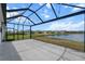 Screened-in patio with view of lake and houses on the far shoreline at 13915 Mount Laurel Trl, Bradenton, FL 34211