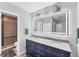 Modern bathroom featuring a double vanity, stylish mirror, and tiled shower with glass doors at 1612 Shady Leaf Dr, Valrico, FL 33596