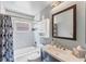 Bathroom featuring tiled shower, dark wood vanity and modern fixtures at 1612 Shady Leaf Dr, Valrico, FL 33596
