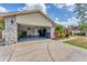 Spacious garage with epoxy floors, stone facade, and ample storage space for vehicles and equipment at 1612 Shady Leaf Dr, Valrico, FL 33596
