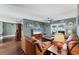Comfortable living room with hardwood floors, leather seating and view to pool area at 1612 Shady Leaf Dr, Valrico, FL 33596