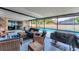 Relaxing screened patio featuring a BBQ, furniture, and a refreshing swimming pool at 1612 Shady Leaf Dr, Valrico, FL 33596