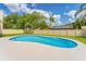 Inviting backyard pool surrounded by a manicured lawn and privacy fence, perfect for relaxation and outdoor enjoyment at 1612 Shady Leaf Dr, Valrico, FL 33596