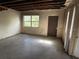 This is a living room with a window, door and exposed ceiling at 1758 35Th St, Sarasota, FL 34234