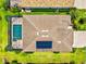 Aerial view of a well-maintained home featuring a private pool, solar panels, and lush green landscaping at 17728 Polo Trail, Lakewood Ranch, FL 34211
