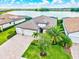 Aerial view of home, roof, lawn, driveway and lake in the background at 17728 Polo Trail, Lakewood Ranch, FL 34211