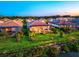 Aerial view of a beautiful home with a screened-in pool area and lush green landscaping close to the lake at 17728 Polo Trail, Lakewood Ranch, FL 34211