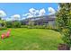 Well manicured backyard with lush landscaping and pink chair at 17728 Polo Trail, Lakewood Ranch, FL 34211