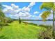 Scenic backyard features a lake, lush landscaping, and comfortable seating at 17728 Polo Trail, Lakewood Ranch, FL 34211