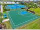 Aerial view of the basketball court with nearby tennis court and lake at 17728 Polo Trail, Lakewood Ranch, FL 34211