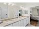 Bright bathroom featuring granite countertops, double sinks, and an adjacent bedroom at 17728 Polo Trail, Lakewood Ranch, FL 34211