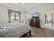 Relaxing bedroom with hardwood flooring, tray ceiling, and large entertainment center at 17728 Polo Trail, Lakewood Ranch, FL 34211