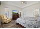 Spacious bedroom features a walk-in closet, tray ceiling, and hardwood flooring at 17728 Polo Trail, Lakewood Ranch, FL 34211
