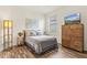 Inviting bedroom features wood floors, natural light, and decorative furnishings at 17728 Polo Trail, Lakewood Ranch, FL 34211