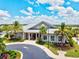 Stunning clubhouse featuring lush landscaping, palm trees, and a beautiful building that creates a welcoming atmosphere at 17728 Polo Trail, Lakewood Ranch, FL 34211