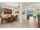 Spacious dining room with neutral tile flooring, large chandelier, and view of outdoor patio at 17728 Polo Trail, Lakewood Ranch, FL 34211