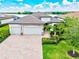 Stunning aerial view of home with well-manicured lawn, two-car garage, and brick driveway at 17728 Polo Trail, Lakewood Ranch, FL 34211
