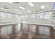 Bright fitness room featuring hardwood floors, natural light, and ceiling fans at 17728 Polo Trail, Lakewood Ranch, FL 34211