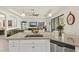 Open kitchen with granite countertops and stainless steel appliances overlooks the living area at 17728 Polo Trail, Lakewood Ranch, FL 34211