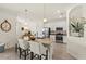 Bright kitchen with white cabinets, stainless appliances, and island with seating at 17728 Polo Trail, Lakewood Ranch, FL 34211