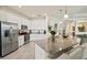 Well-lit kitchen boasts modern appliances, granite countertops, and open floorplan at 17728 Polo Trail, Lakewood Ranch, FL 34211