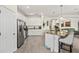Bright kitchen with white cabinets, stainless steel appliances, and breakfast bar seating at 17728 Polo Trail, Lakewood Ranch, FL 34211