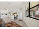 Living space with kitchen beyond and view of the screened lanai at 17728 Polo Trail, Lakewood Ranch, FL 34211