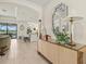 Open living area with tile floors, built-in buffet, and an island with stools at 17728 Polo Trail, Lakewood Ranch, FL 34211
