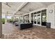 Covered patio area furnished with cozy seating and ceiling fans, creating a relaxing outdoor space at 17728 Polo Trail, Lakewood Ranch, FL 34211