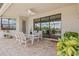 Paver patio with outdoor dining set, ceiling fan, and sliders leading into the home at 17728 Polo Trail, Lakewood Ranch, FL 34211