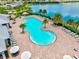 Aerial view of the pool with lake view and chaise lounges at 17728 Polo Trail, Lakewood Ranch, FL 34211