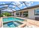Screened-in pool and spa with access to outdoor living and backyard at 17728 Polo Trail, Lakewood Ranch, FL 34211