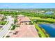 Wide aerial shot showcasing townhomes alongside serene lakes, lush greenery, and vibrant neighborhood landscapes at 23528 Awabuki Dr # 101, Venice, FL 34293
