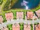 An aerial view of several beautiful tile roofed homes adjacent to a pond and well manicured lawns at 23528 Awabuki Dr # 101, Venice, FL 34293