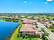 Beautiful aerial view of a townhome community featuring water views and lush tropical landscaping at 23528 Awabuki Dr # 101, Venice, FL 34293