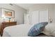 Comfortable bedroom with a large bed, dresser, and neutral color scheme at 23528 Awabuki Dr # 101, Venice, FL 34293