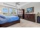 Bedroom with tray ceiling, natural light, and en suite bathroom at 23528 Awabuki Dr # 101, Venice, FL 34293