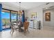 Charming dining area with a stylish chandelier and sliding door to the patio at 23528 Awabuki Dr # 101, Venice, FL 34293
