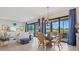 Stylish dining area adjoining the living room, featuring a glass table and scenic views at 23528 Awabuki Dr # 101, Venice, FL 34293