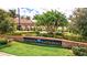 Sarasota National entrance sign surrounded by lush landscaping and palm trees at 23528 Awabuki Dr # 101, Venice, FL 34293