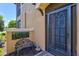 Cozy front entrance features a screened door, seating and colorful plants at 23528 Awabuki Dr # 101, Venice, FL 34293