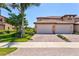 Beautiful exterior features a paver driveway, a two car garage and lush landscaping at 23528 Awabuki Dr # 101, Venice, FL 34293