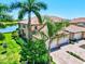 Stunning aerial view of a well-maintained home with manicured lawns and a picturesque lake nearby at 23528 Awabuki Dr # 101, Venice, FL 34293