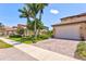 Home featuring a spacious two-car garage, with a paved driveway and landscaped front yard at 23528 Awabuki Dr # 101, Venice, FL 34293
