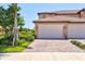 Home featuring a two-car garage and a brick driveway in a well-maintained neighborhood at 23528 Awabuki Dr # 101, Venice, FL 34293