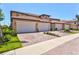 Townhome featuring multiple garages and beautifully brick paved driveways, enhancing curb appeal at 23528 Awabuki Dr # 101, Venice, FL 34293