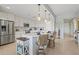 Bright kitchen with a large island, stainless steel appliances, and pendant lighting at 23528 Awabuki Dr # 101, Venice, FL 34293