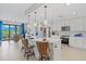 Bright open kitchen with a large island, stainless steel appliances, and seating for entertaining at 23528 Awabuki Dr # 101, Venice, FL 34293