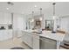 Kitchen island with stainless steel appliances, white cabinets, granite countertop, and pendant lighting at 23528 Awabuki Dr # 101, Venice, FL 34293