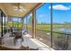 Spacious screened-in lanai offering serene lake views, perfect for outdoor relaxation and dining at 23528 Awabuki Dr # 101, Venice, FL 34293